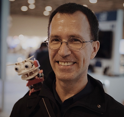 Picture of Michael D. McCool along with Ralph, his robot familiar.